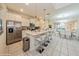 Open concept kitchen with island, stainless steel appliances, and view into dining area at 5452 Misty Oak Cir, Davenport, FL 33837