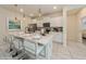 Modern kitchen with white cabinets, stainless steel appliances, and kitchen island at 5452 Misty Oak Cir, Davenport, FL 33837