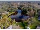 Aerial view of home and surrounding lake at 646 Palm Dr, Oviedo, FL 32765