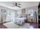 Light and airy bedroom with hardwood floors, large windows and ceiling fan at 646 Palm Dr, Oviedo, FL 32765