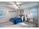 Bedroom with a queen-size bed, ceiling fan, and built-in shelving at 646 Palm Dr, Oviedo, FL 32765