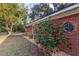 Brick ranch house with blooming camellia bushes and well-manicured lawn at 646 Palm Dr, Oviedo, FL 32765