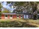 Ranch style brick home with a teal front door and lush lawn at 646 Palm Dr, Oviedo, FL 32765