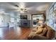 Living room with hardwood floors, fireplace and view of kitchen at 646 Palm Dr, Oviedo, FL 32765