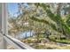 Scenic view of a lake with lush landscaping from a window at 700 Melrose Ave # A 22, Winter Park, FL 32789