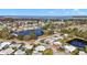 Aerial view of waterfront community with lush landscaping and many homes at 711 Dolphin Dr, Tavares, FL 32778