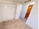 Bedroom with double door closet and access to bathroom at 711 Dolphin Dr, Tavares, FL 32778