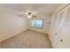 Spacious carpeted bedroom with large closet and window at 711 Dolphin Dr, Tavares, FL 32778