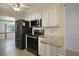 Modern kitchen with black appliances and granite countertops at 711 Dolphin Dr, Tavares, FL 32778