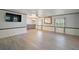 Spacious living room with wood-look floors and built-in shelving at 711 Dolphin Dr, Tavares, FL 32778