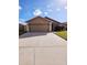 Two-car garage and a light brown house at 7132 Holly Creek Rd, Mount Dora, FL 32757