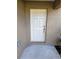 White front door with silver hardware at 7132 Holly Creek Rd, Mount Dora, FL 32757