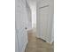 Bright hallway with tile floors and white doors at 7132 Holly Creek Rd, Mount Dora, FL 32757