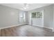 Light-filled bedroom with wood-look floors and ceiling fan at 802 Rugby St # 802, Orlando, FL 32804