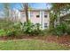 Building exterior showcasing a light pink building with mature trees and landscaping at 802 Rugby St # 802, Orlando, FL 32804