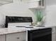 Clean stovetop with four burners and a black oven at 802 Rugby St # 802, Orlando, FL 32804