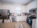 Modern kitchen with white cabinets and stainless steel appliances at 8044 Lost Shaker Ln, Kissimmee, FL 34747