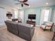 Relaxing living room with gray sectional and wooden coffee table at 8044 Lost Shaker Ln, Kissimmee, FL 34747