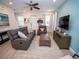 Comfortable living room with gray sectional sofa and large TV at 8044 Lost Shaker Ln, Kissimmee, FL 34747