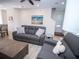 Spacious living room with gray couches and ocean-themed art at 8044 Lost Shaker Ln, Kissimmee, FL 34747