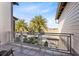 Private balcony with metal railing and view of palm trees at 8136 Tavistock Lakes Blvd, Orlando, FL 32827