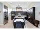 Modern kitchen with dark cabinets, quartz countertops, and an island at 8136 Tavistock Lakes Blvd, Orlando, FL 32827