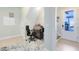 Small home office with a desk and chair near the entrance at 8136 Tavistock Lakes Blvd, Orlando, FL 32827