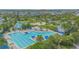 Community lap pool and leisure pool with lounge chairs at 8136 Tavistock Lakes Blvd, Orlando, FL 32827