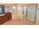 Bathroom with corner tub, shower, and wood cabinets at 910 Gran Bahama Blvd # 910, Davenport, FL 33897