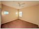 Well-lit bedroom with carpet and two windows at 910 Gran Bahama Blvd # 910, Davenport, FL 33897