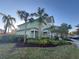 Green building with landscaping and palm trees at 910 Gran Bahama Blvd # 910, Davenport, FL 33897