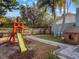 Playful backyard with playset, landscaping, and a spacious yard at 922 Fort Smith Blvd, Deltona, FL 32738