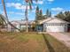 Charming ranch home with teal exterior, two-car garage, and lush landscaping at 922 Fort Smith Blvd, Deltona, FL 32738