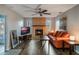 Living room with fireplace, orange couch, and wood floors at 922 Fort Smith Blvd, Deltona, FL 32738