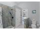 Modern bathroom with walk-in shower, stylish tile, and a toilet at 1004 Hornbeam St, Oviedo, FL 32765