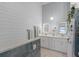 Spa-like bathroom with double vanity, shiplap walls and walk-in shower at 1004 Hornbeam St, Oviedo, FL 32765