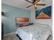 Bedroom with large TV, ceiling fan, and coastal decor at 1004 Hornbeam St, Oviedo, FL 32765