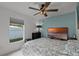 Bedroom with ceiling fan, dresser and large TV at 1004 Hornbeam St, Oviedo, FL 32765