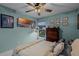 Bedroom with a large TV, ceiling fan, and comfortable bed at 1004 Hornbeam St, Oviedo, FL 32765