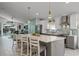 Modern kitchen with white and gray cabinets, quartz countertops, and an island at 1004 Hornbeam St, Oviedo, FL 32765