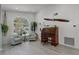 Spacious living room with an antique roll top desk and large window at 1004 Hornbeam St, Oviedo, FL 32765