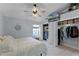 Main bedroom with walk-in closet, ceiling fan, and window at 1004 Hornbeam St, Oviedo, FL 32765