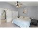 Main bedroom with sliding barn door, en-suite bathroom, and ceiling fan at 1004 Hornbeam St, Oviedo, FL 32765