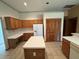 Kitchen with an island and wooden cabinets at 1017 Pearl Tree Rd, Deltona, FL 32725