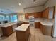 Kitchen with an island and wooden cabinets at 1017 Pearl Tree Rd, Deltona, FL 32725