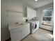 Bright laundry room, washer and dryer hookups, and storage cabinets at 1017 Pearl Tree Rd, Deltona, FL 32725