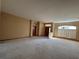 Large living room with neutral carpeting and ample natural light at 1017 Pearl Tree Rd, Deltona, FL 32725