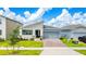 Modern single story home with gray siding, two-car garage and landscaping at 1146 Boardwalk Pl, Kissimmee, FL 34747