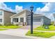 Modern one-story house with gray siding and a brick driveway at 1146 Boardwalk Pl, Kissimmee, FL 34747