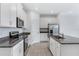 Modern kitchen featuring granite countertops and white cabinetry at 1146 Boardwalk Pl, Kissimmee, FL 34747